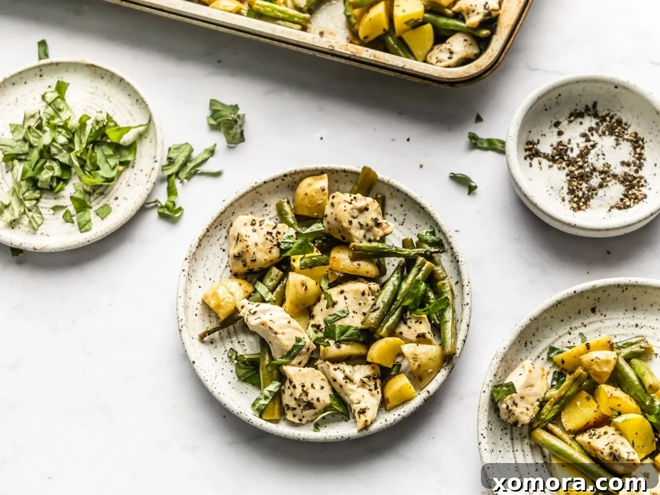 Sheet Pan Lemon Chicken Dinner with lemon slices and herbs.