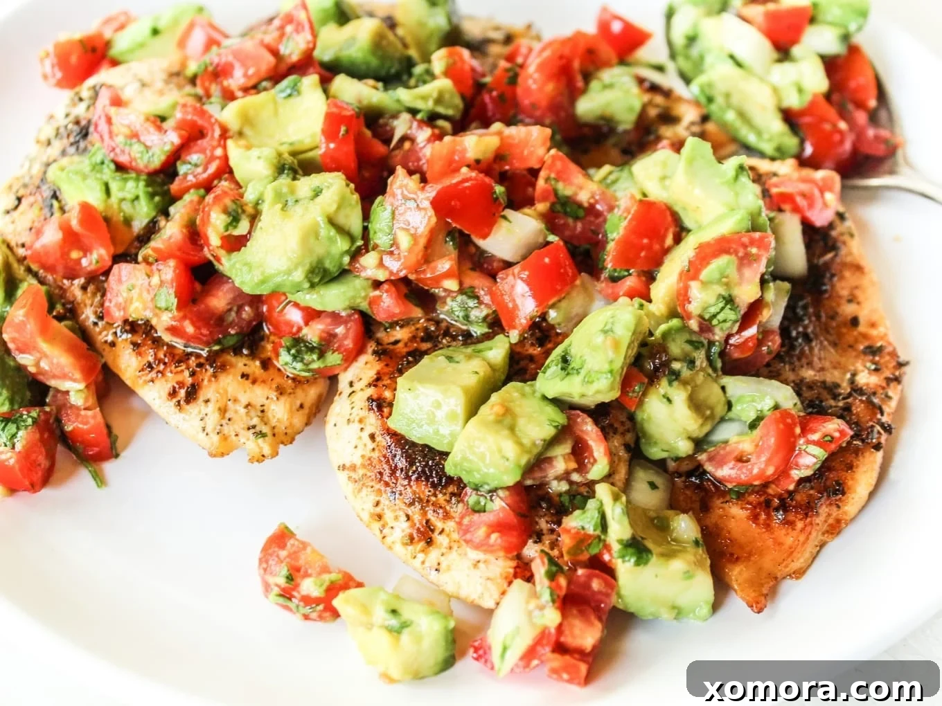 Avocado Salsa Chicken, topped with fresh avocado and cilantro.