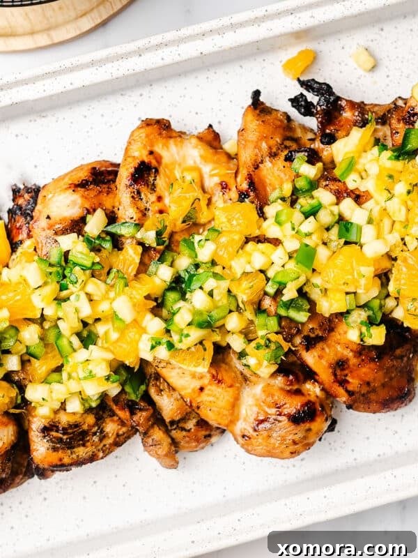 Tropical Salsa Grilled Chicken, garnished with colorful salsa.