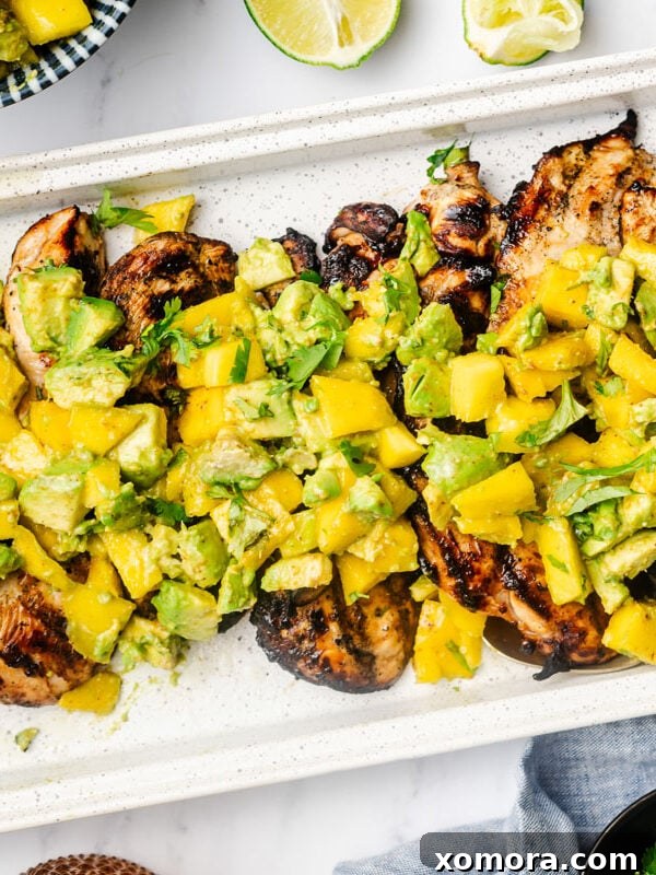 Avocado Mango Chicken, topped with fresh avocado and mango salsa.
