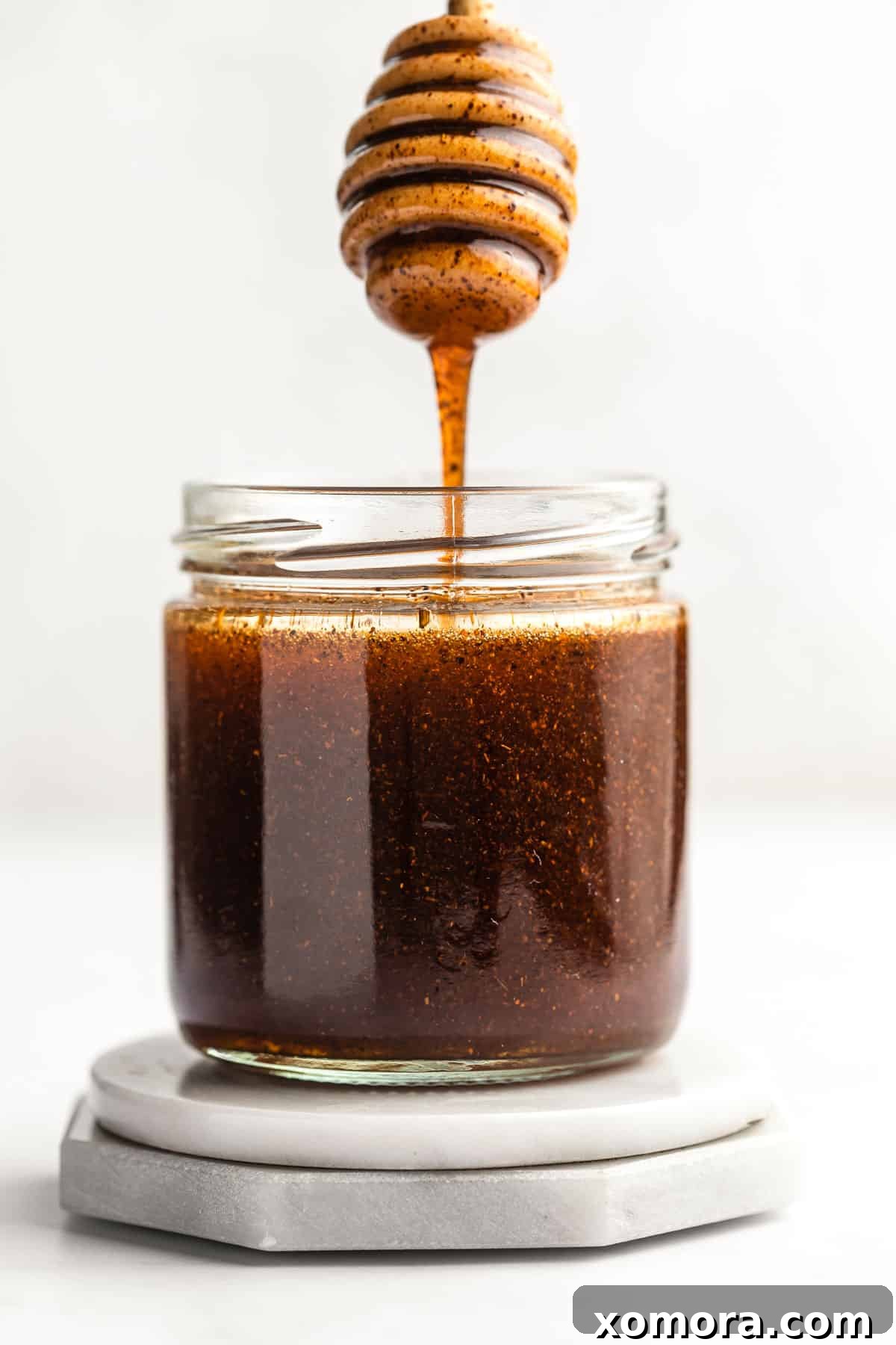 Sweet Heat Honey Drizzle 2 A jar of golden homemade hot honey sauce, ready to be drizzled over delicious food.