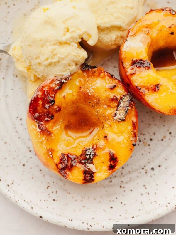 Grilled Peaches with Vanilla Ice Cream, garnished with mint.