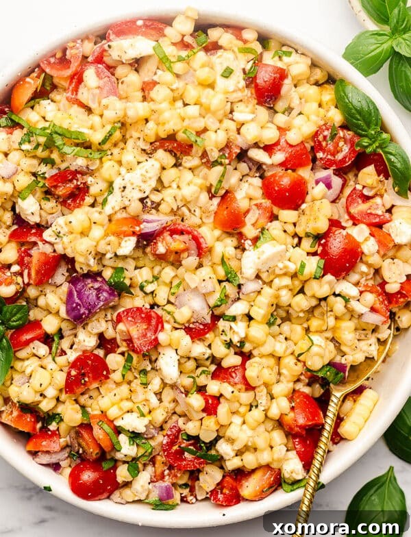Grilled Corn Salad in a bowl, garnished with fresh herbs.