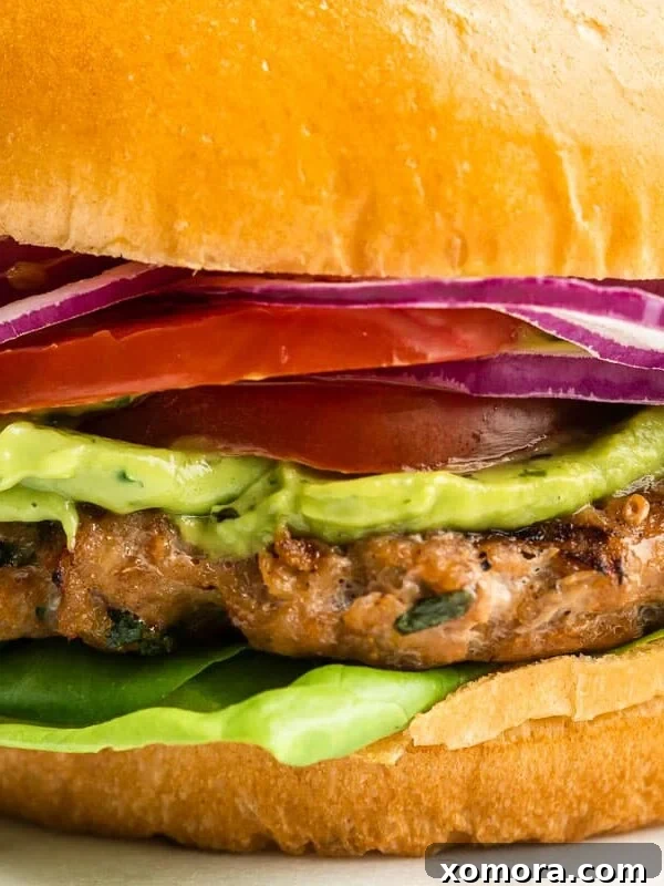 Healthy Grilled Turkey Burgers on a bun with fresh toppings.