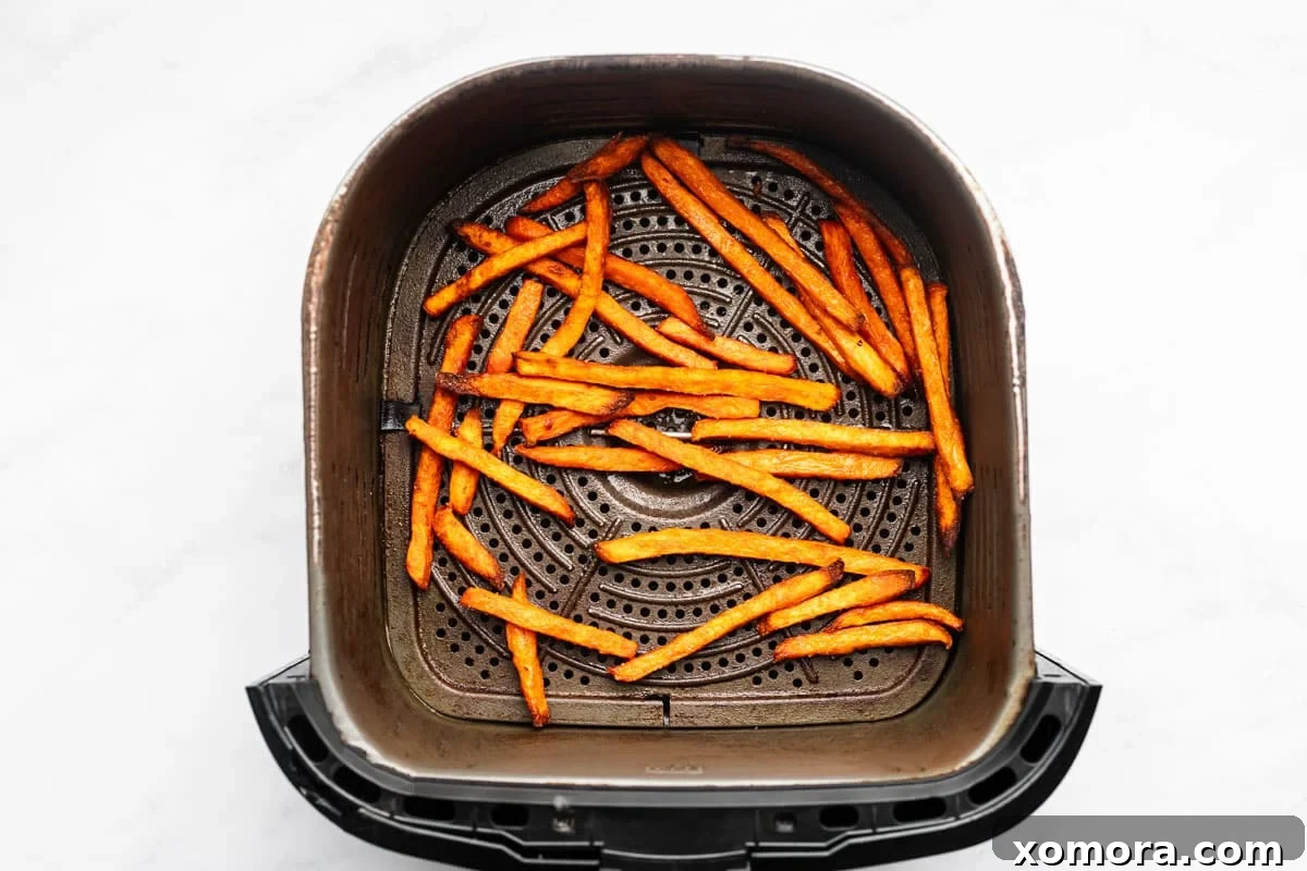Perfect Air Fryer Sweet Potato Fries 4 Air fryer basket filled with sweet potato fries