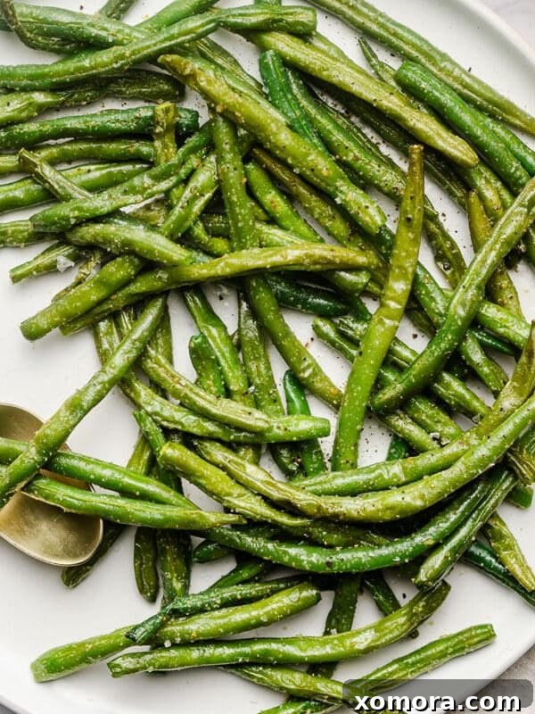 Easy Air Fryer Frozen Green Beans, charred edges, served in a bowl.