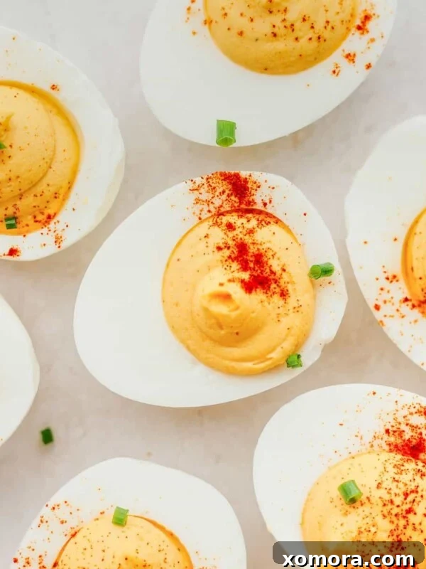 Easy Deviled Eggs with Paprika, garnished with fresh parsley.