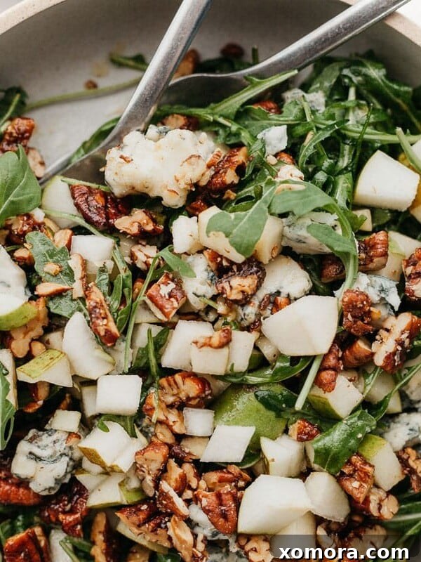 Arugula Pear Salad with Candied Pecans, beautifully plated.