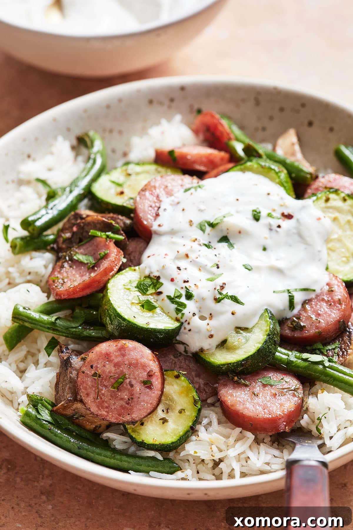 Wholesome Sausage & Vegetable Bowls with Tangy Yogurt Dressing 7 The finished Sausage and Veggie Bowls, presented elegantly in a bowl, showcasing the vibrant colors and appealing texture of the meal.