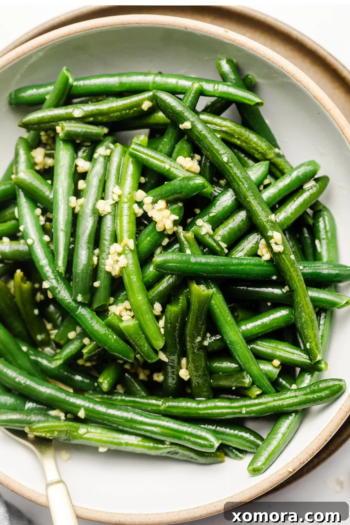 Crisp Garlic Green Beans 2 Close-up of vibrant green sautéed garlic green beans in a skillet.