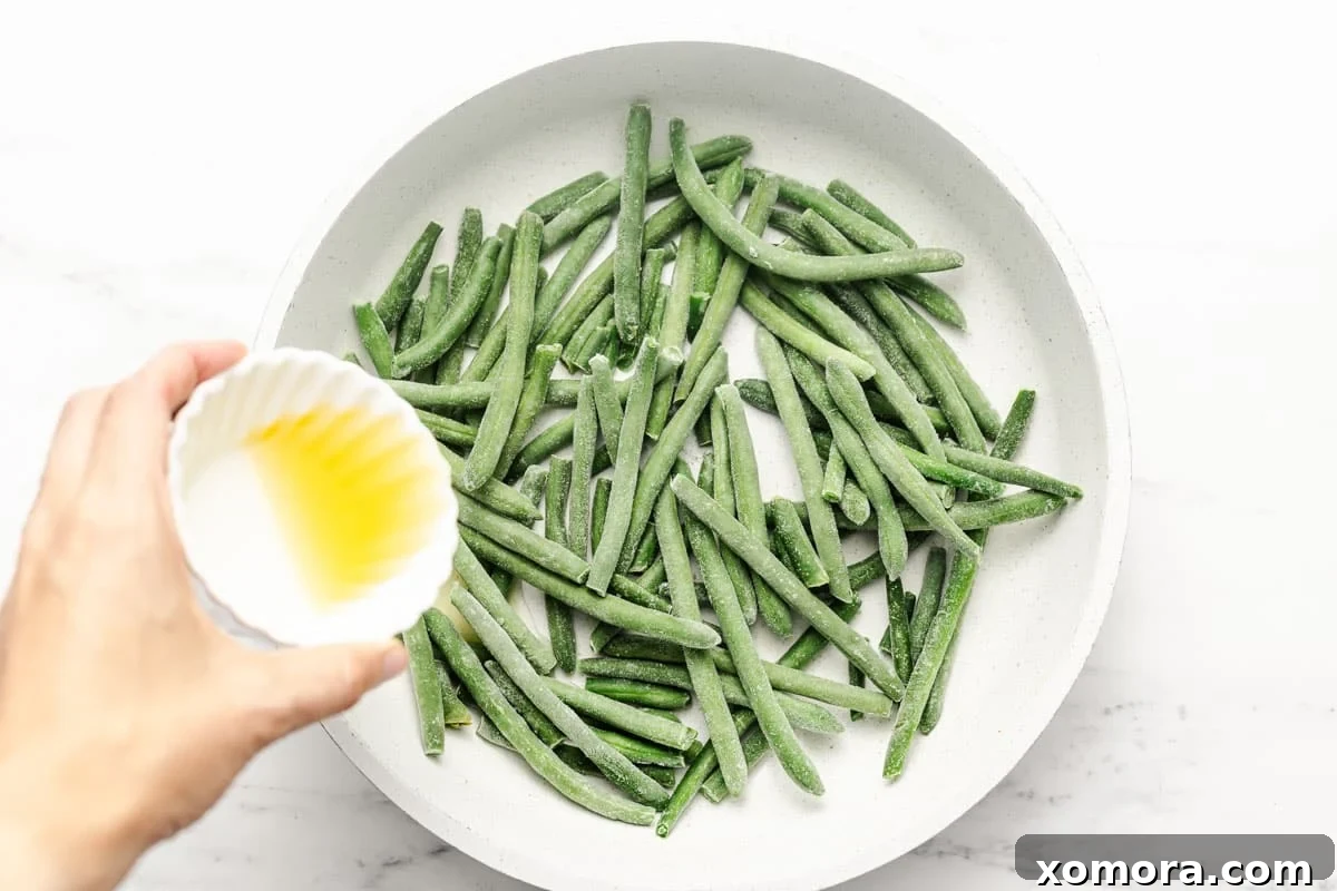 Crisp Garlic Green Beans 4 Freshly minced garlic next to a bowl of green beans, illustrating key ingredients.