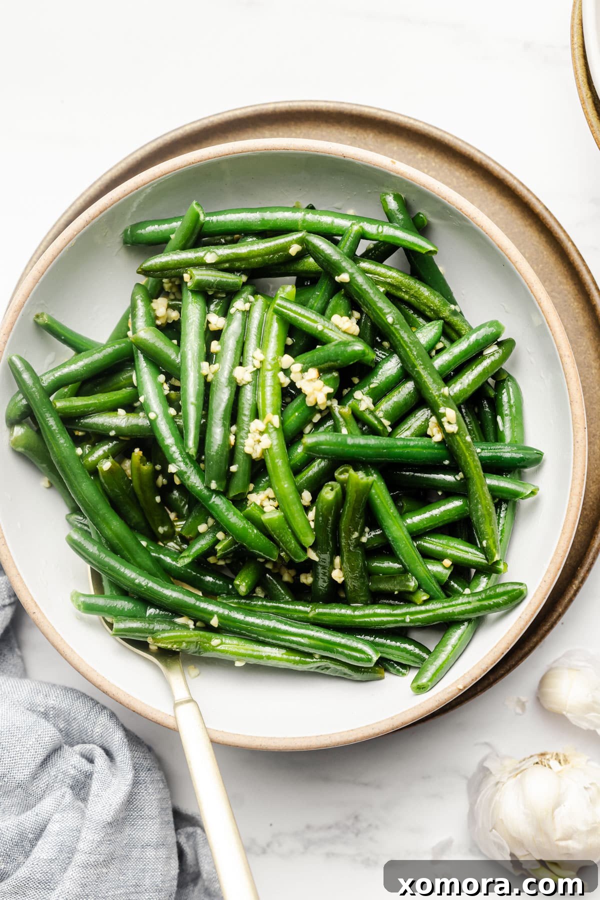 Crisp Garlic Green Beans 6 A close-up shot of sautéed garlic green beans in a rustic bowl, ready to be served.