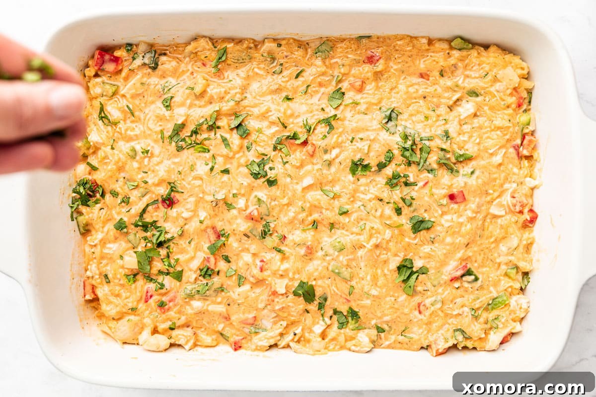 Ingredients for Buffalo Ranch Casserole being mixed in a bowl.