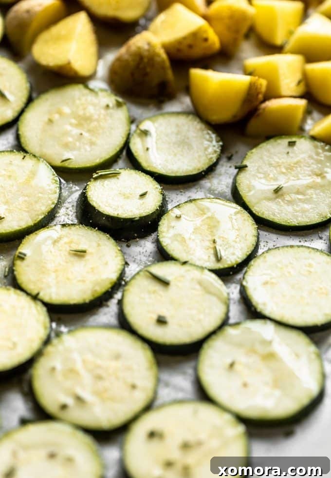 Sheet Pan Chicken with Roasted Potatoes and Zucchini 3 A selection of raw ingredients for sheet pan dinner: chicken breasts, baby Dutch yellow potatoes, zucchini, garlic, and fresh herbs.