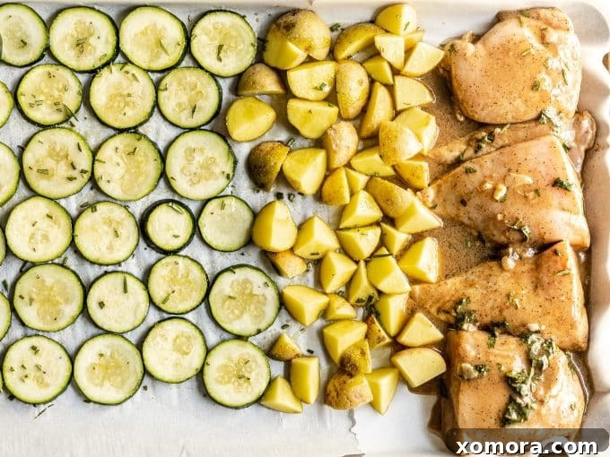 Sheet Pan Chicken with Roasted Potatoes and Zucchini 4 Close-up of fresh rosemary sprigs and garlic cloves, key aromatics for the marinade.