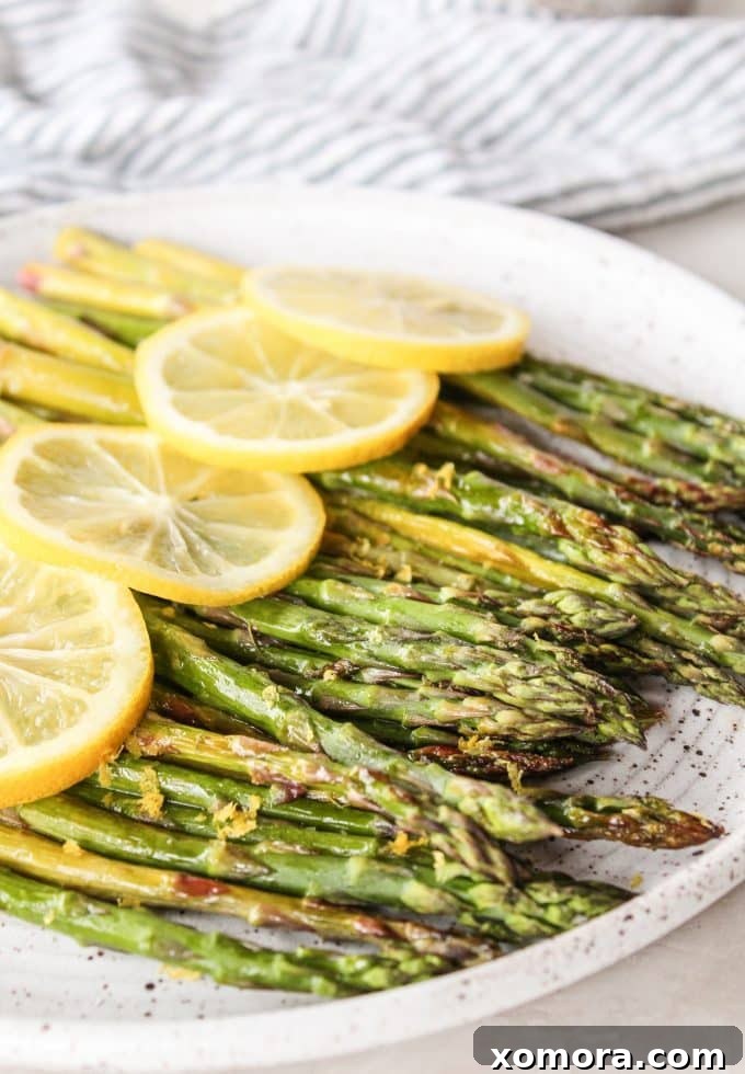 Zesty Roasted Asparagus 3 Close-up of roasted asparagus spears on a baking sheet, ready for serving.