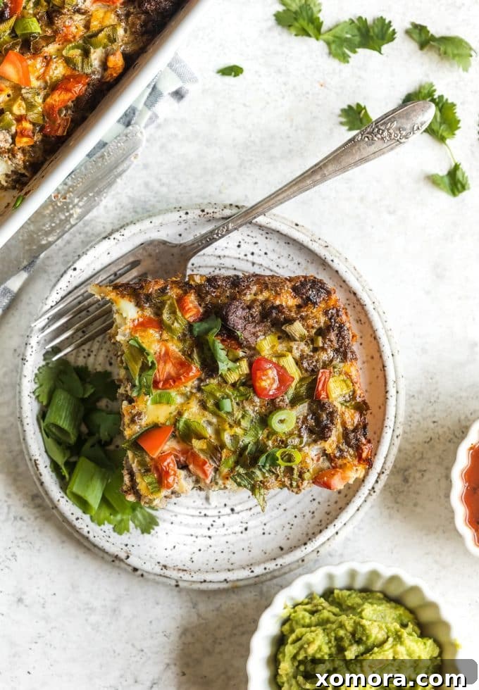 Zesty Plant-Based Mexican Breakfast Bake 3 Close-up of the Dairy-Free Mexican Breakfast Casserole, showcasing the texture of the shredded potatoes and the vibrant colors of the bell peppers and green onions.