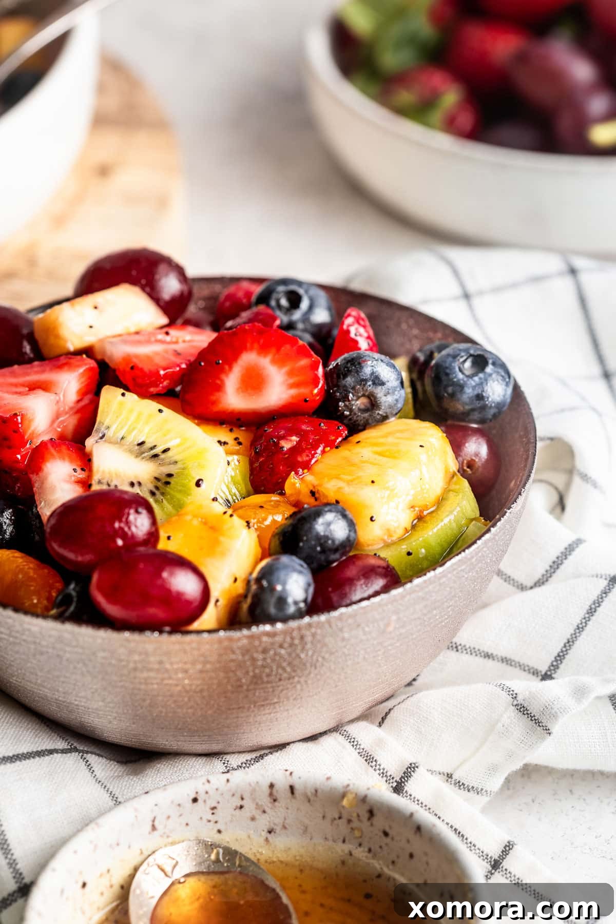 Vibrant Fruit Medley with Lemon Poppy Seed Drizzle 4 Another close-up of the fruit salad, featuring a mix of colorful fruits and the light, refreshing lemon poppy seed dressing.