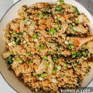 Wholesome Cauliflower Chicken Fried Rice 6 A beautifully plated dish of cauliflower chicken fried rice, rich with vegetables and golden brown chicken pieces.