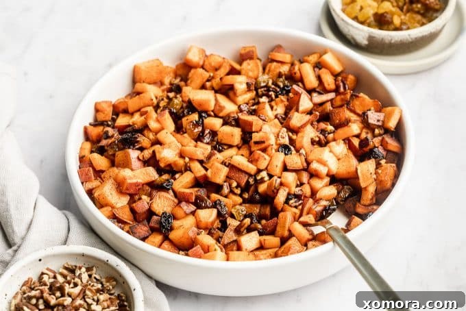 Close-up of diced sweet potatoes cooking in a skillet with coconut oil