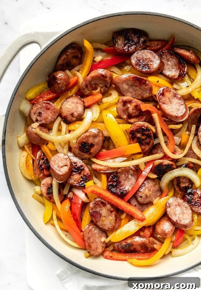 Vibrant Sausage and Peppers Skillet with a mix of colorful bell peppers, ready to be served over rice.