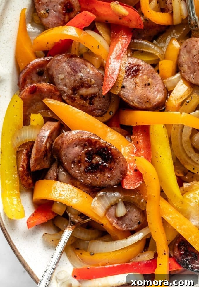 Sausage and Peppers Skillet in a pan, ready for final seasoning and serving.