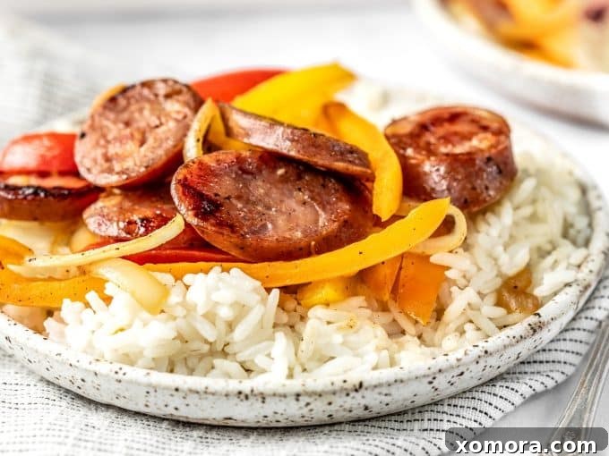 A serving of Sausage and Peppers Skillet with white rice, showing a balanced meal.