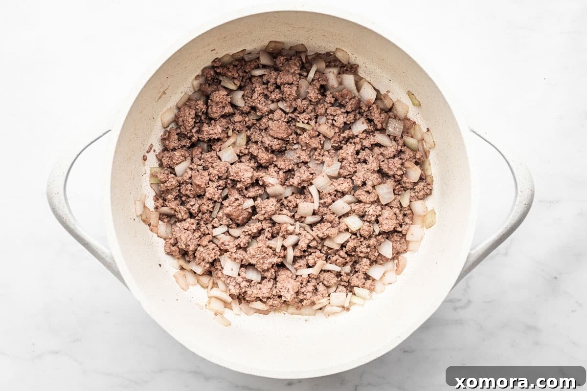 Close-up of healthy 30-minute hamburger soup with visible chunks of beef, potatoes, and vegetables.
