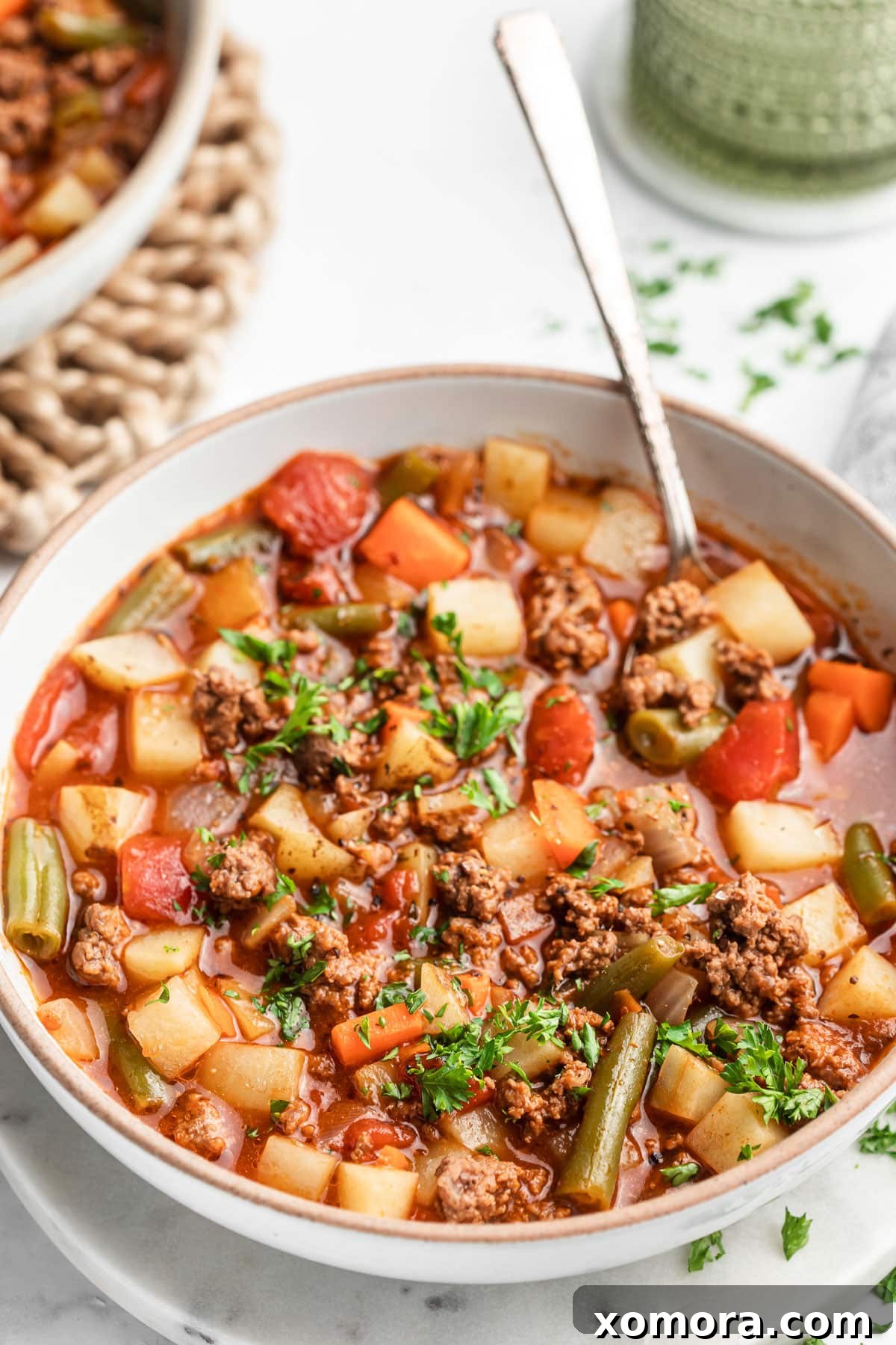 A beautifully presented bowl of healthy 30-minute hamburger soup, ready to be served.