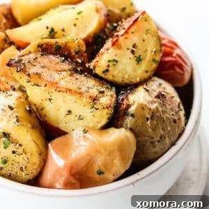 Simply Roasted Apples & Potatoes plated with herbs