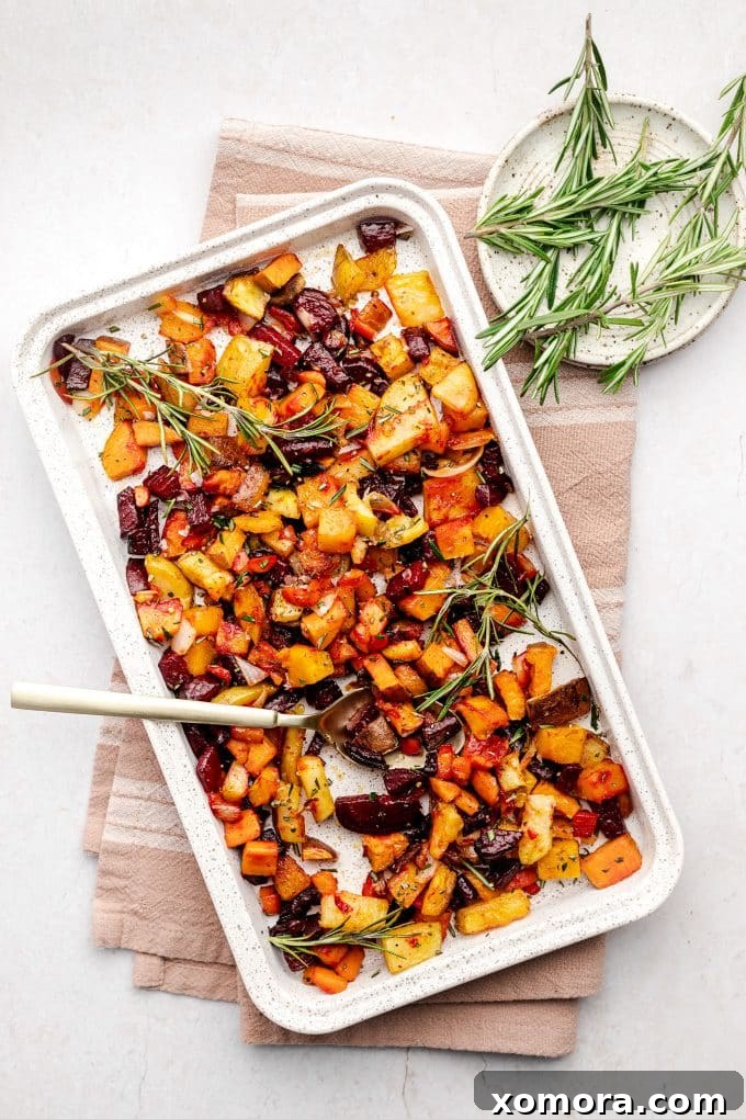 Herb-Kissed Roasted Root Medley 4 A serving of roasted root vegetables, garnished with fresh rosemary, ready to be enjoyed as a healthy and flavorful side dish.