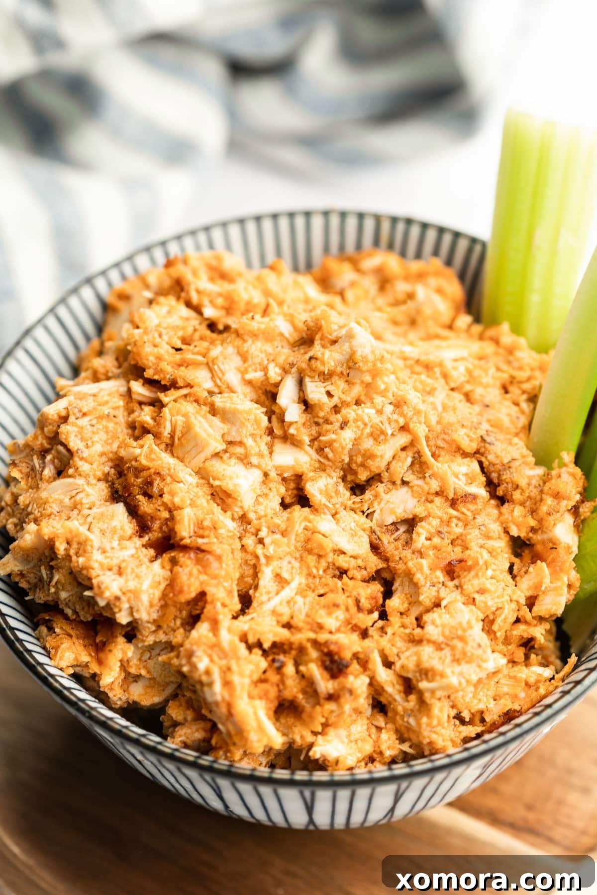 Kickin Dairy Free Buffalo Ranch Chicken Dip 2 A vibrant, thick Dairy-Free Buffalo Ranch Chicken Dip in a baking dish, ready to be served, perfect for appetizers.