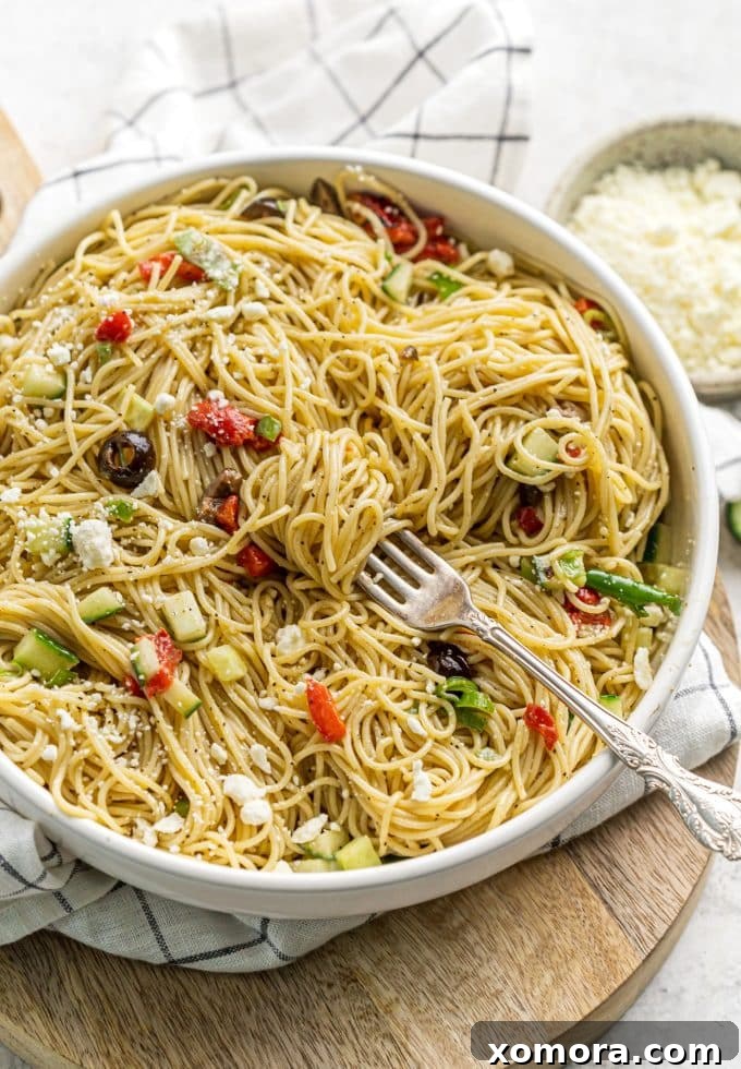 Vibrant 20-Minute Greek Pasta Salad 2 Freshly prepared Greek pasta salad in a large serving bowl, ready to be chilled.