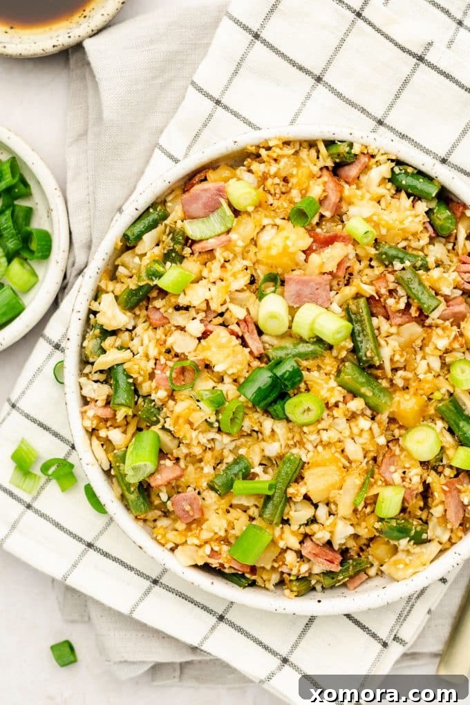 Ingredients for Pineapple Cauliflower Rice laid out on a baking sheet, ready for the oven.