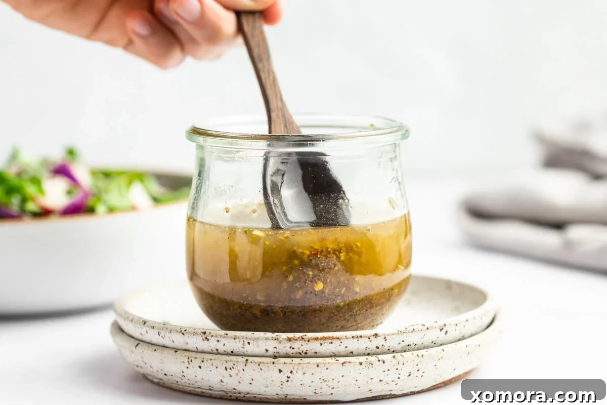 Close-up of homemade Italian dressing in a mason jar.
