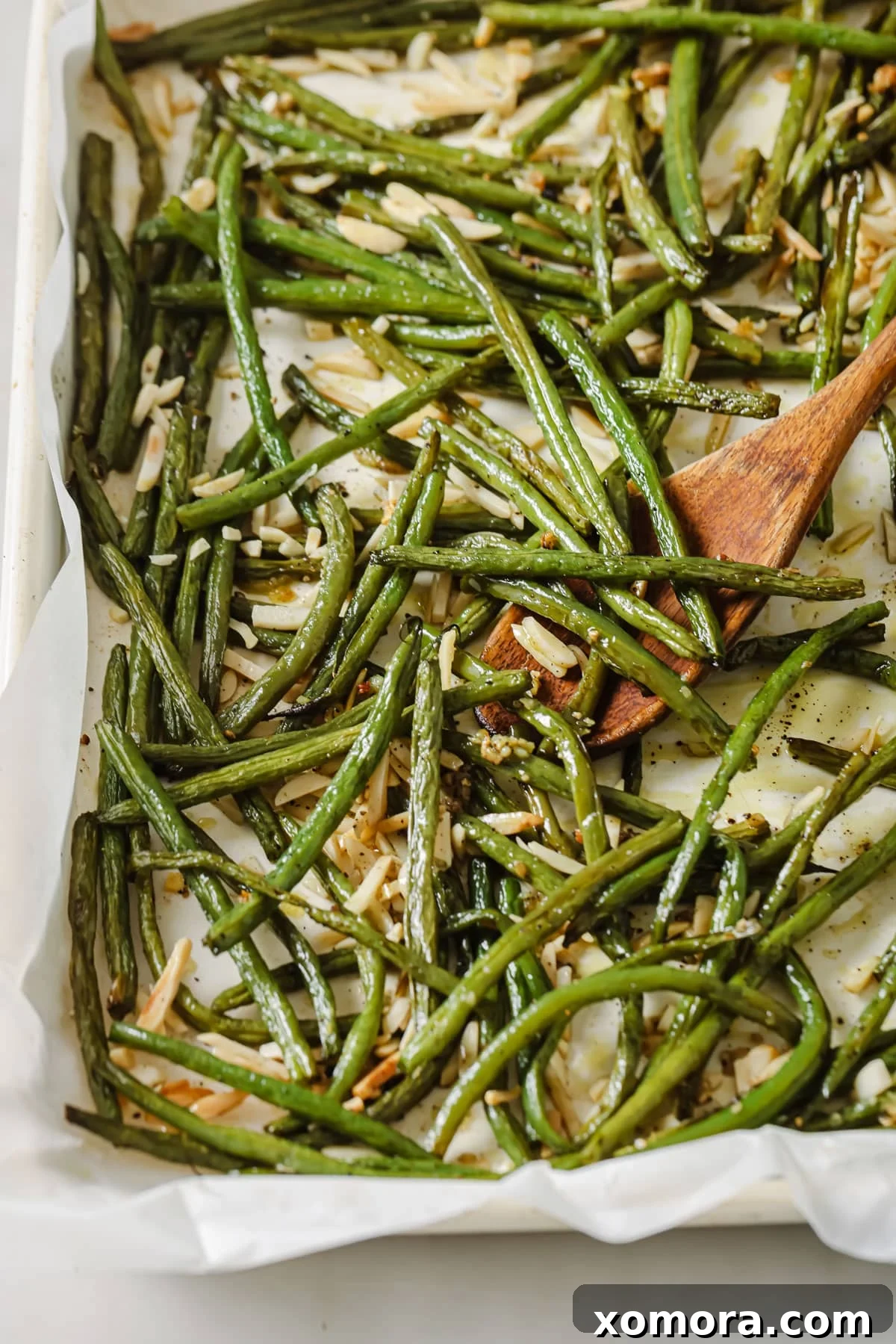 Crispy Roasted Green Beans & Toasted Almonds 2 Freshly roasted green beans tossed with golden brown slivered almonds, ready to serve.