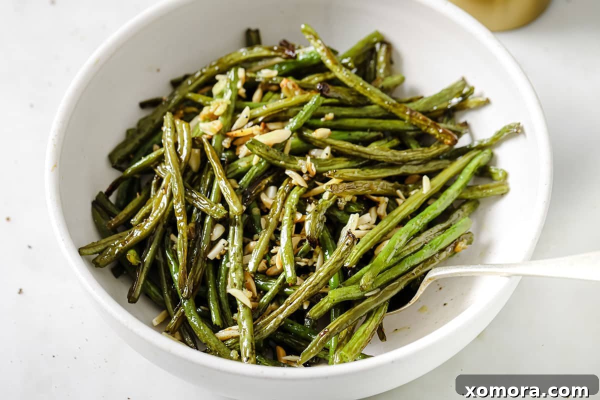 Crispy Roasted Green Beans & Toasted Almonds 4 A bowl of minced garlic and slivered almonds, ready to be added to the roasted green beans.