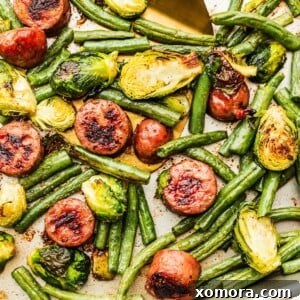 One-Pan Sausage and Roasted Vegetables 6 A top-down shot of the finished Sheet Pan Sausage and Vegetables, garnished and ready to serve.