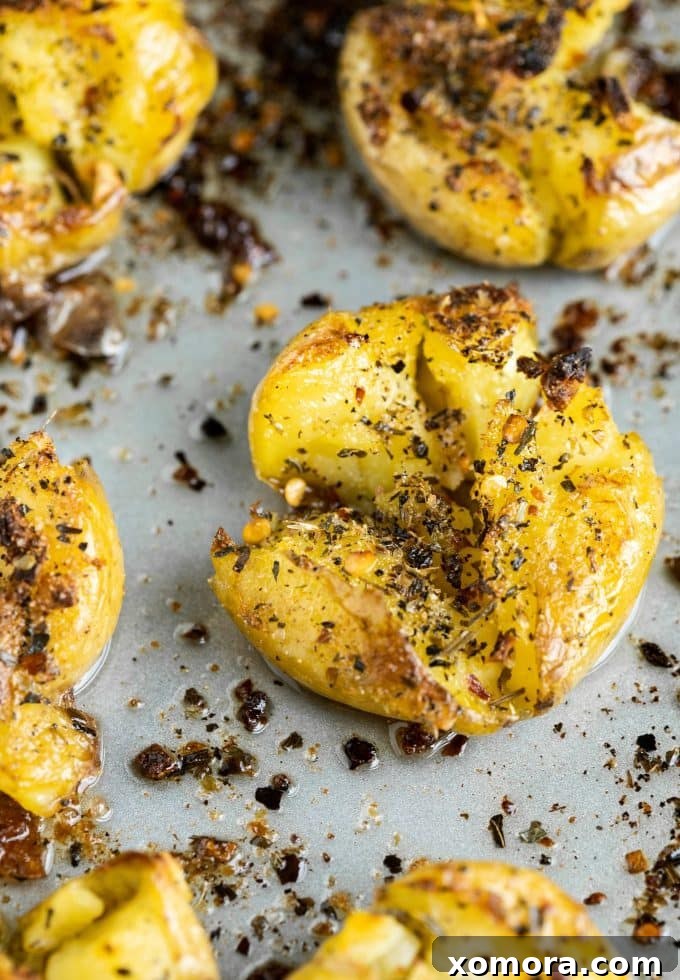 Close-up of golden Smashed & Roasted Italian Potatoes with a rustic texture.