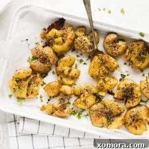 A dish of freshly cooked Smashed & Roasted Italian Potatoes.