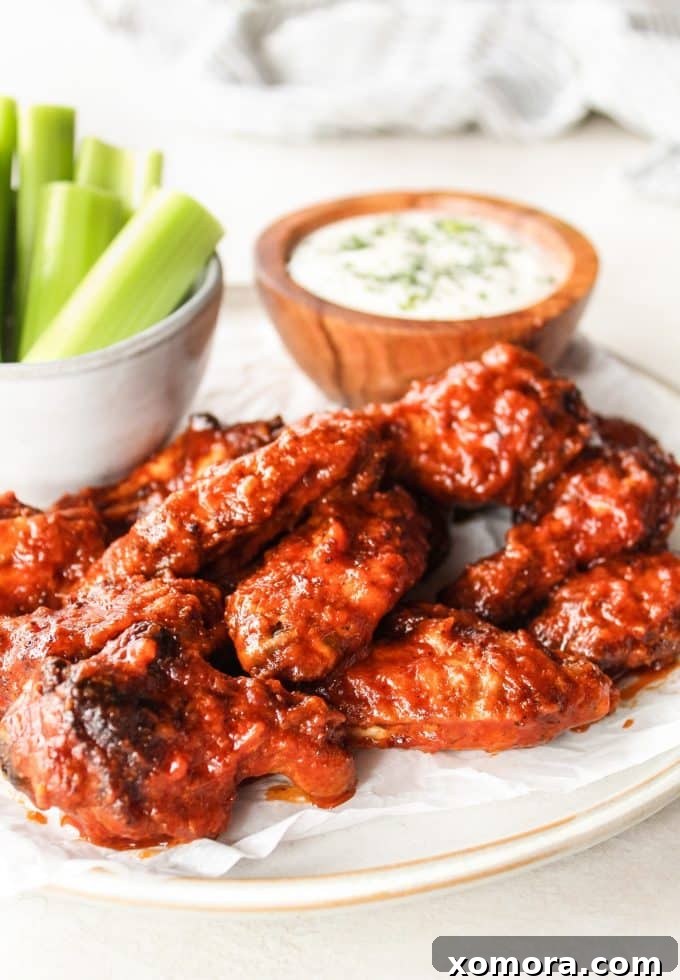 Close-up of baked chicken wings with a rich, spicy dry rub, before being tossed in sauce.