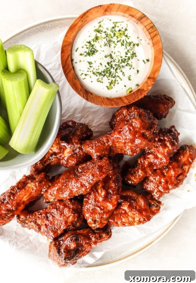 Finished Chipotle Peach Baked Wings, glistening with sauce and ready to be served.