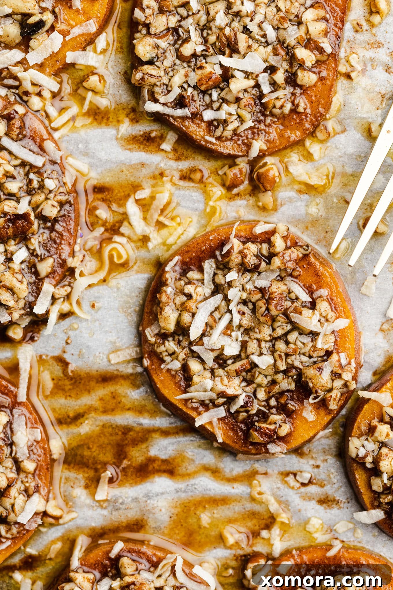 Close-up of baked sweet potato rounds with pecan crumble