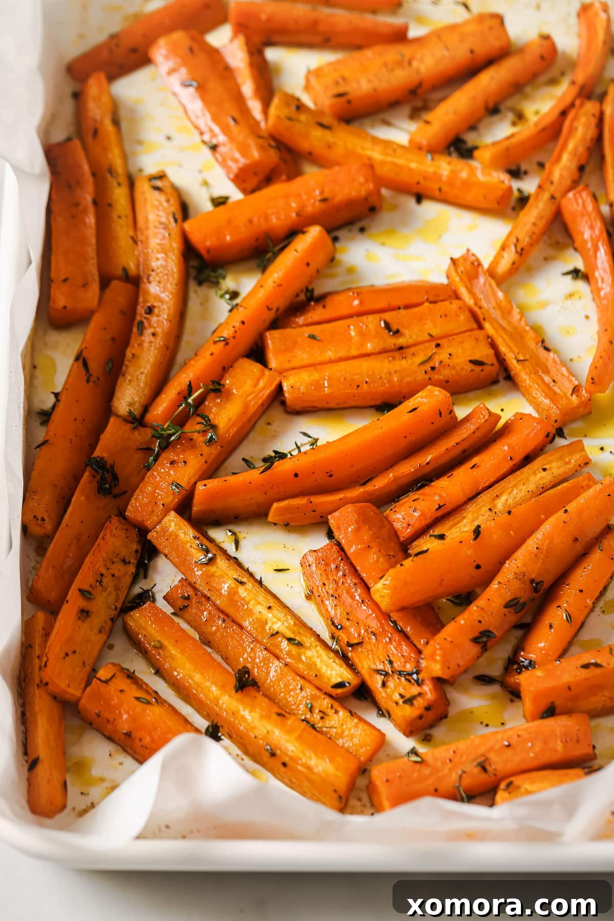 Zesty Lemon Thyme Roasted Carrots 2 Beautifully roasted carrots glistening with lemon and thyme, perfectly golden-brown and ready to serve.
