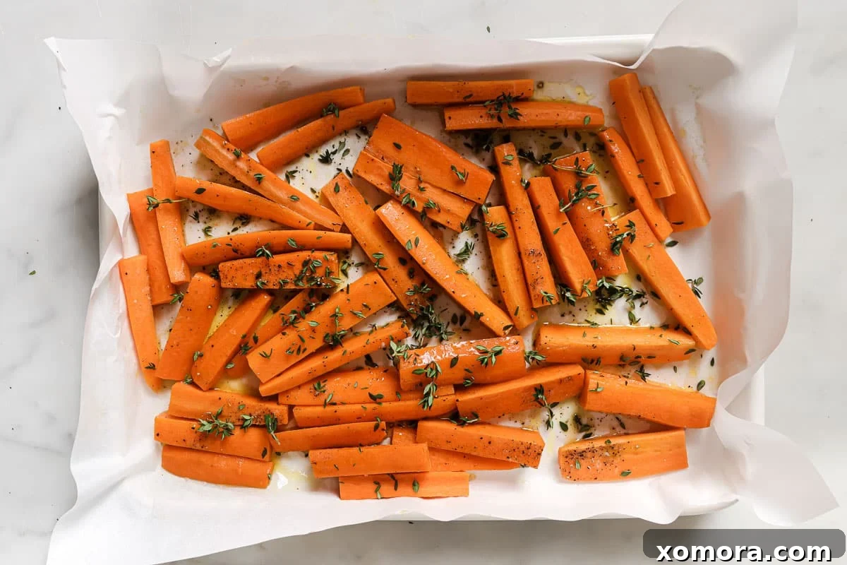 Zesty Lemon Thyme Roasted Carrots 3 Close-up of golden-brown roasted carrots seasoned with fresh thyme sprigs.
