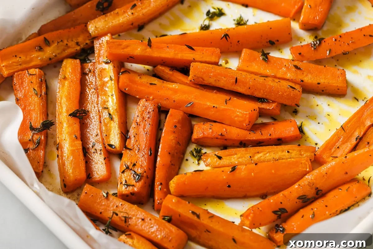 Zesty Lemon Thyme Roasted Carrots 4 Raw carrots, fresh thyme, lemon, olive oil, salt, and pepper on a wooden board before preparation.