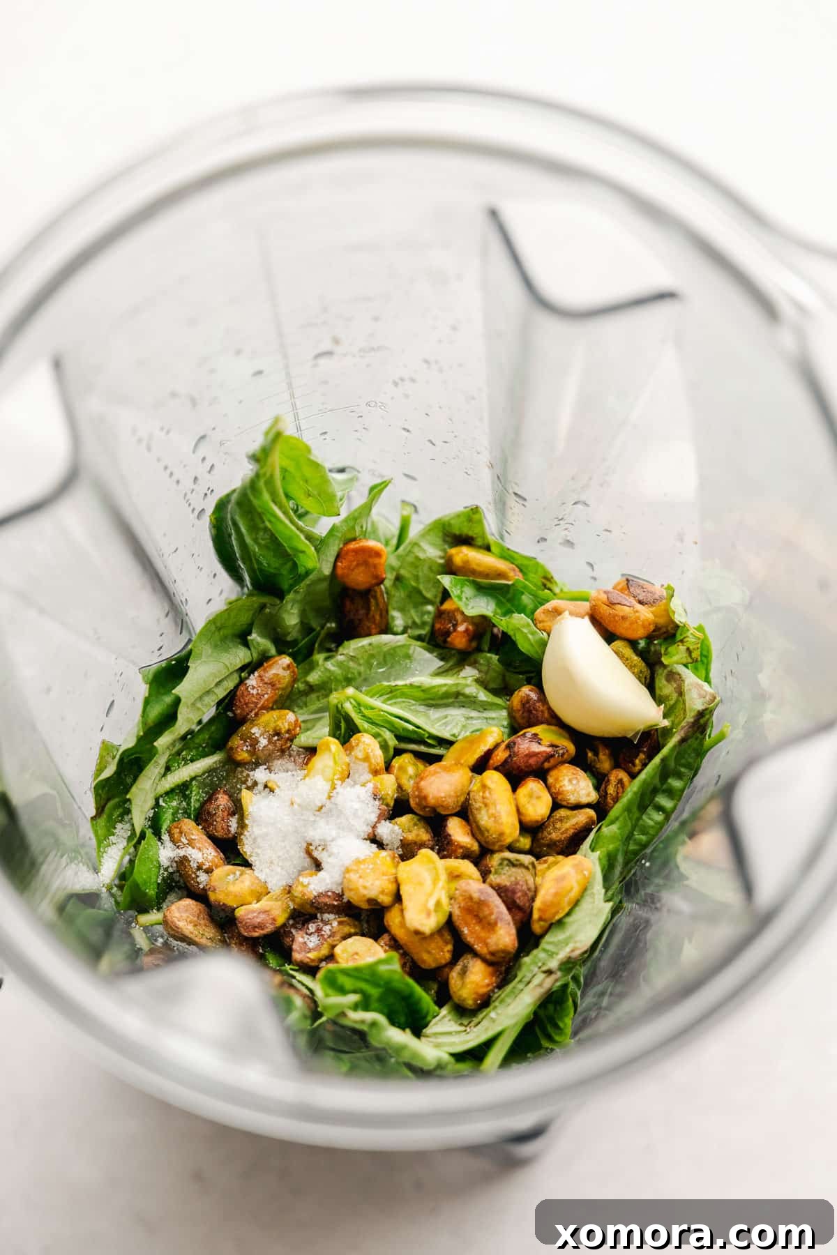 A close-up of the bright green dairy-free pistachio lemon pesto in a bowl, showcasing its creamy texture.
