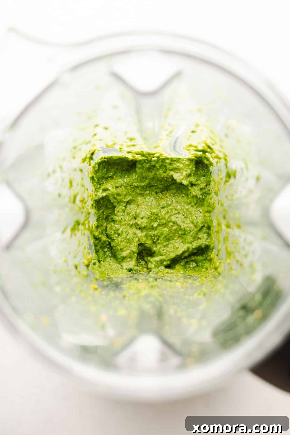 Ingredients for making dairy-free pistachio lemon pesto laid out on a wooden surface.