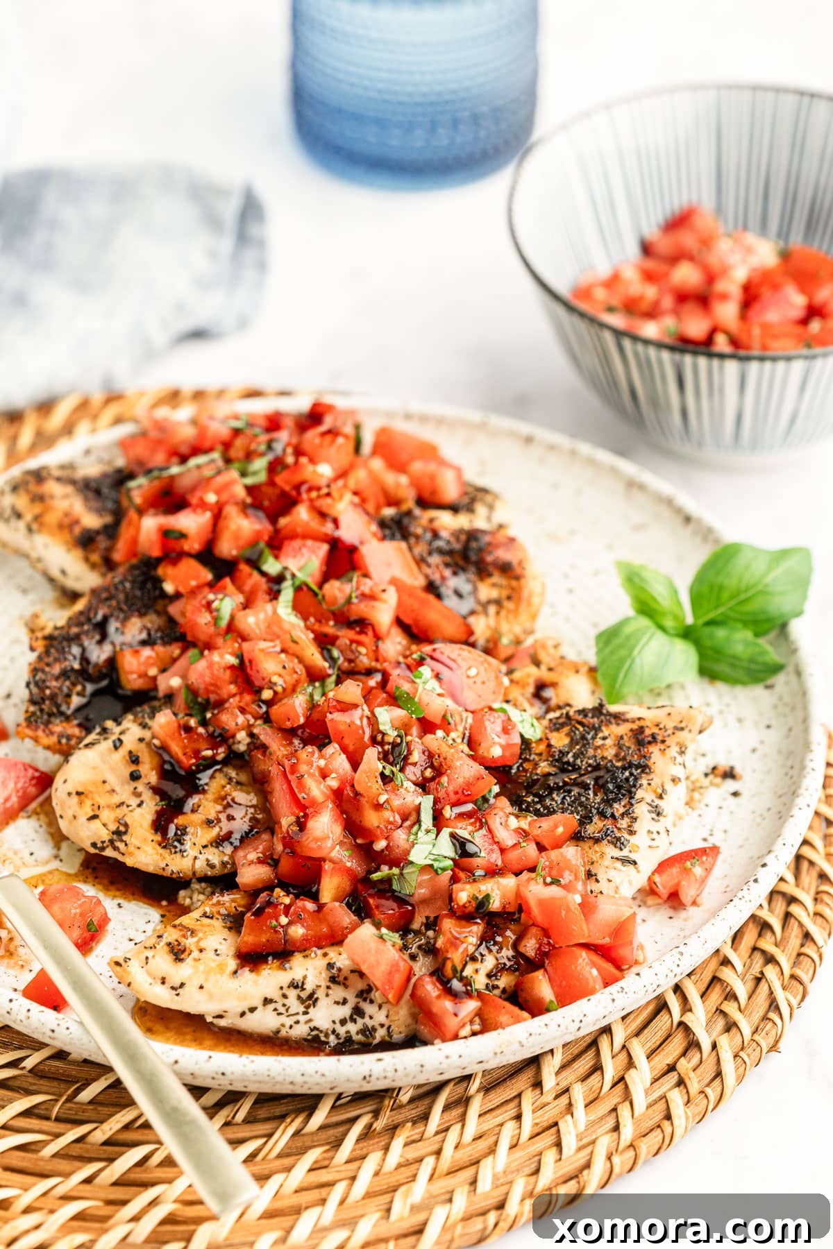 Vibrant Bruschetta Chicken 2 Healthy Bruschetta Chicken served on a plate, garnished with fresh basil leaves.