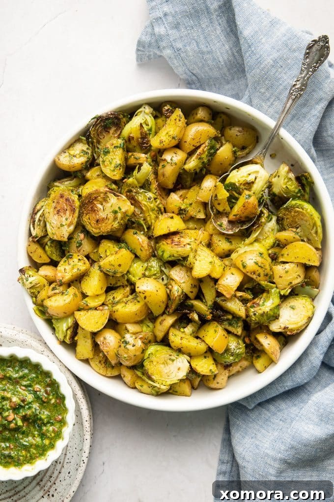 Pesto potatoes and brussels sprouts garnished with fresh herbs